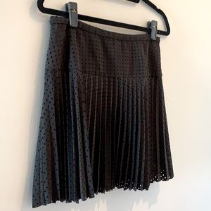 Black pleated skirt with perforated square design